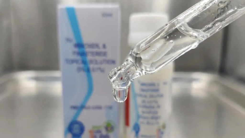 Ultra-detailed macro shot of a dropper dispensing a single drop of Pradhan Mantri Minoxidil topical solution, sharp focus on drop and dropper tip, blurred background, clinical and professional look.