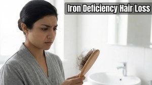 Alt Text iron deficiency hair loss — woman holding brush with excessive hair shedding